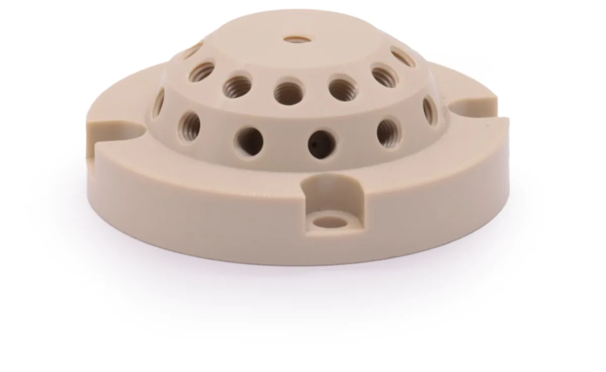Example machined engineering plastic component with functional holes